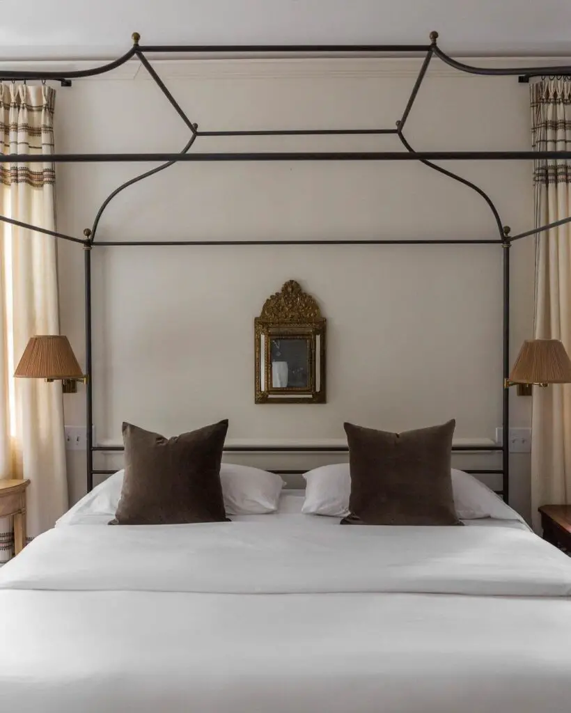 Stylish bedroom with metal canopy bed