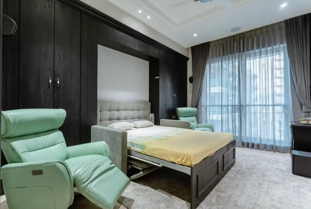 Dark wood bedroom with mint recliners
