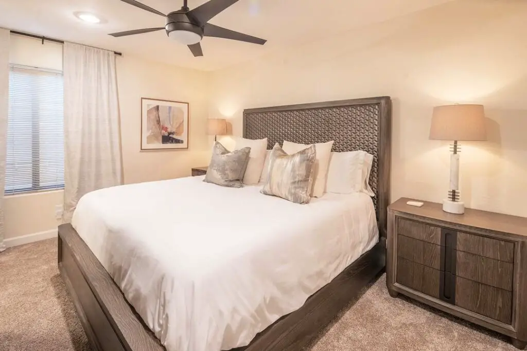 Neutral bedroom with dark wood headboard