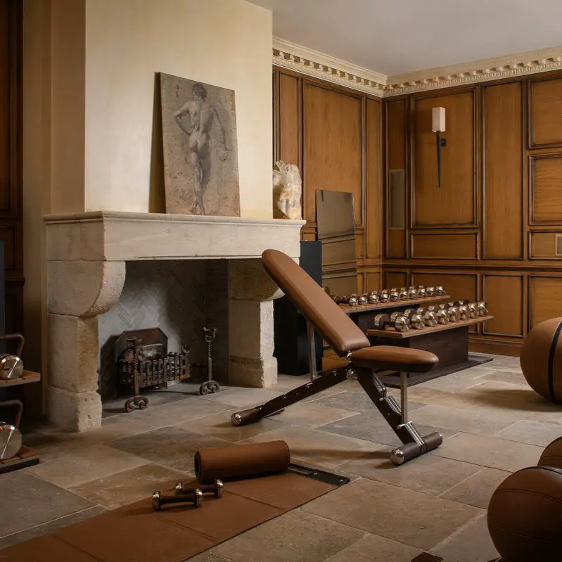 Elegant home gym with antique decor and modern exercise equipment