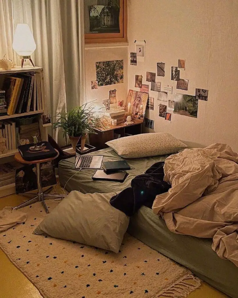 Cozy bedroom corner with books photos and laptop