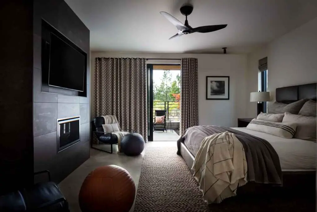 Modern bedroom with fireplace and balcony view