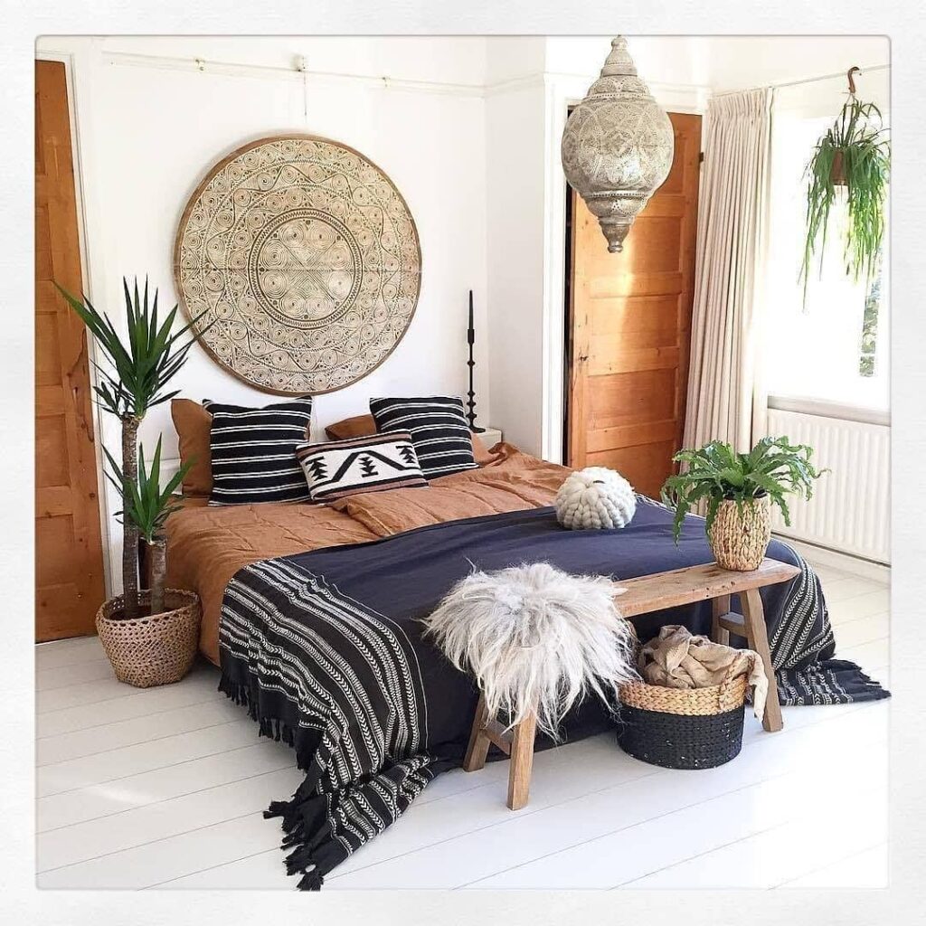 Bohemian bedroom with patterned wall art and plants