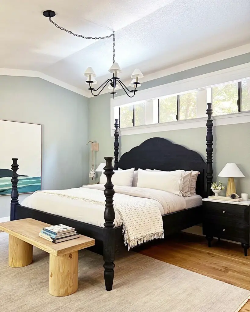 Bedroom with black four-poster bed and coastal decor