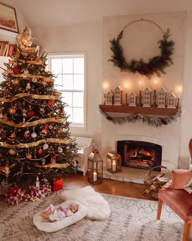 Festive living room with Christmas tree, fireplace, and sleeping baby