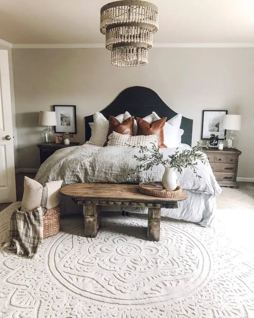 Bedroom with black headboard and beaded chandelier