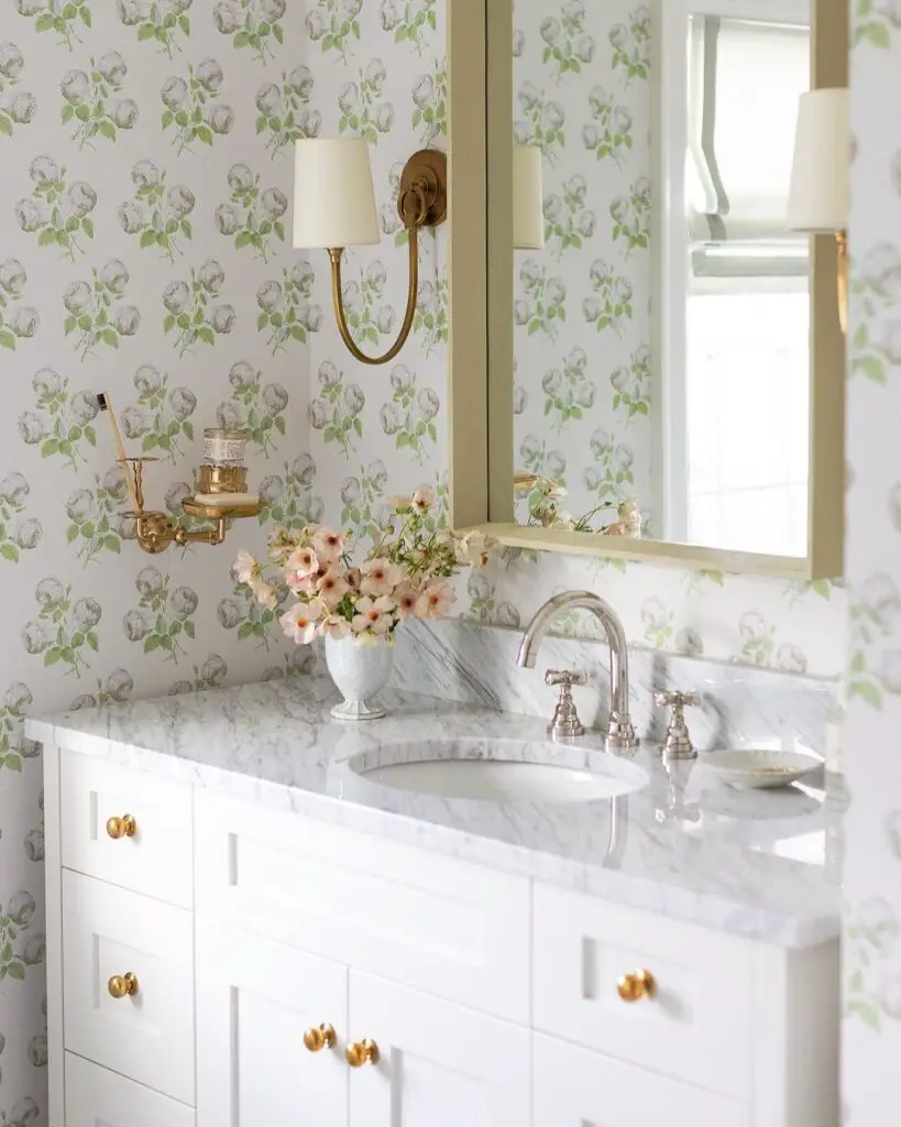Elegant bathroom vanity with floral wallpaper and marble countertop