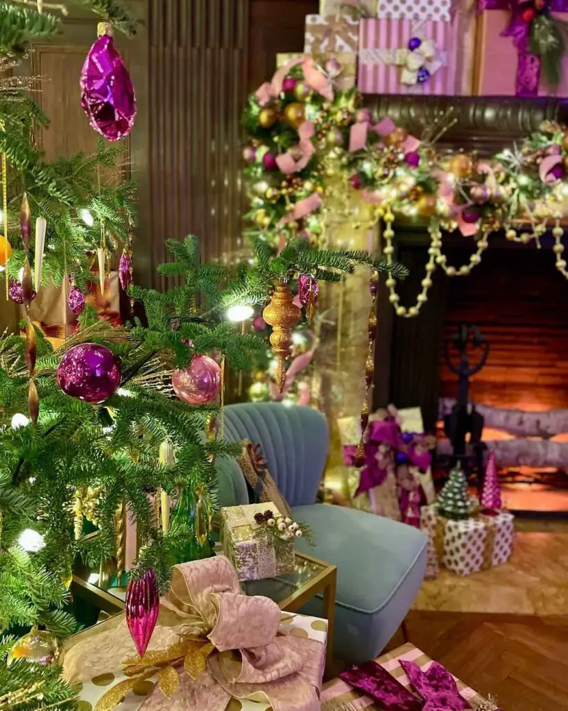 A glamorous living room with a fuchsia and gold decorated Christmas tree, velvet seating