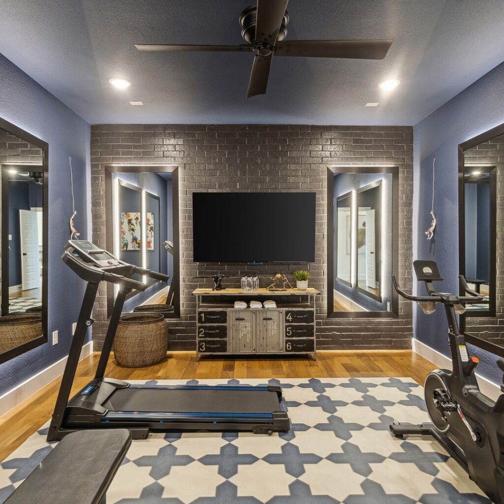 Stylish home gym with brick wall, modern equipment, and vintage storage cabinet