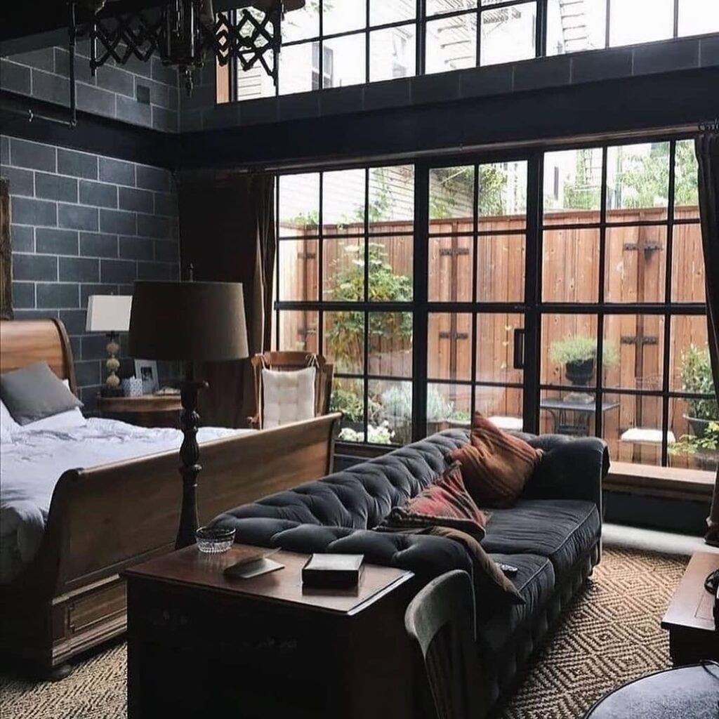 Dark bedroom with large windows and industrial decor