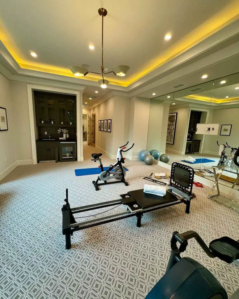 Upscale home gym with varied equipment and mood lighting