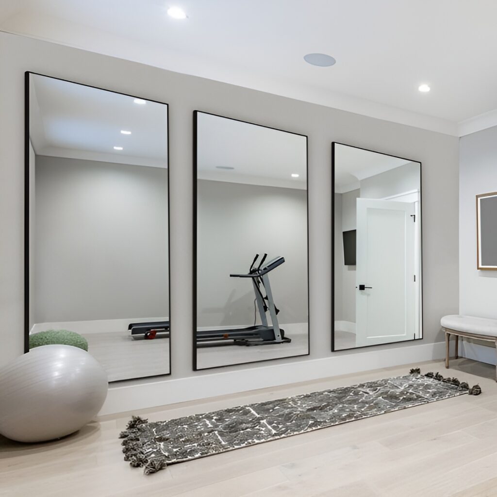 Minimalist home gym with large mirrors and treadmill