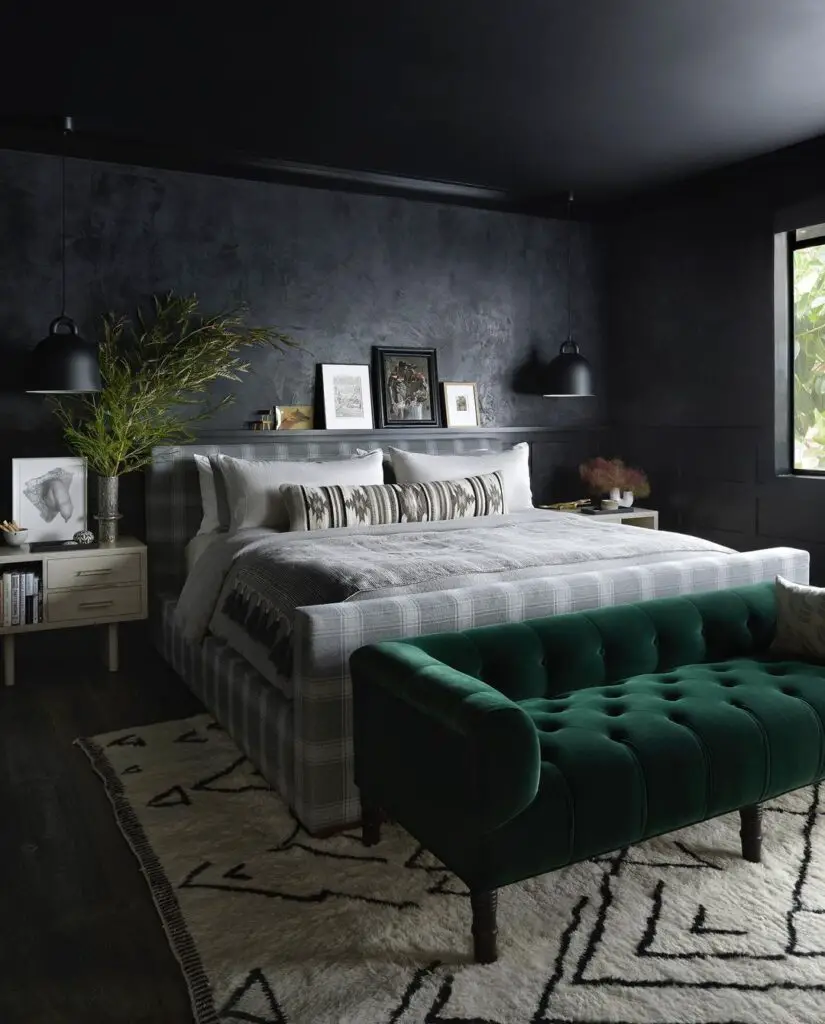 Dark bedroom with gray bed and green velvet bench