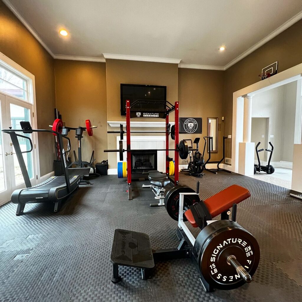 Living room converted to home gym with various equipment