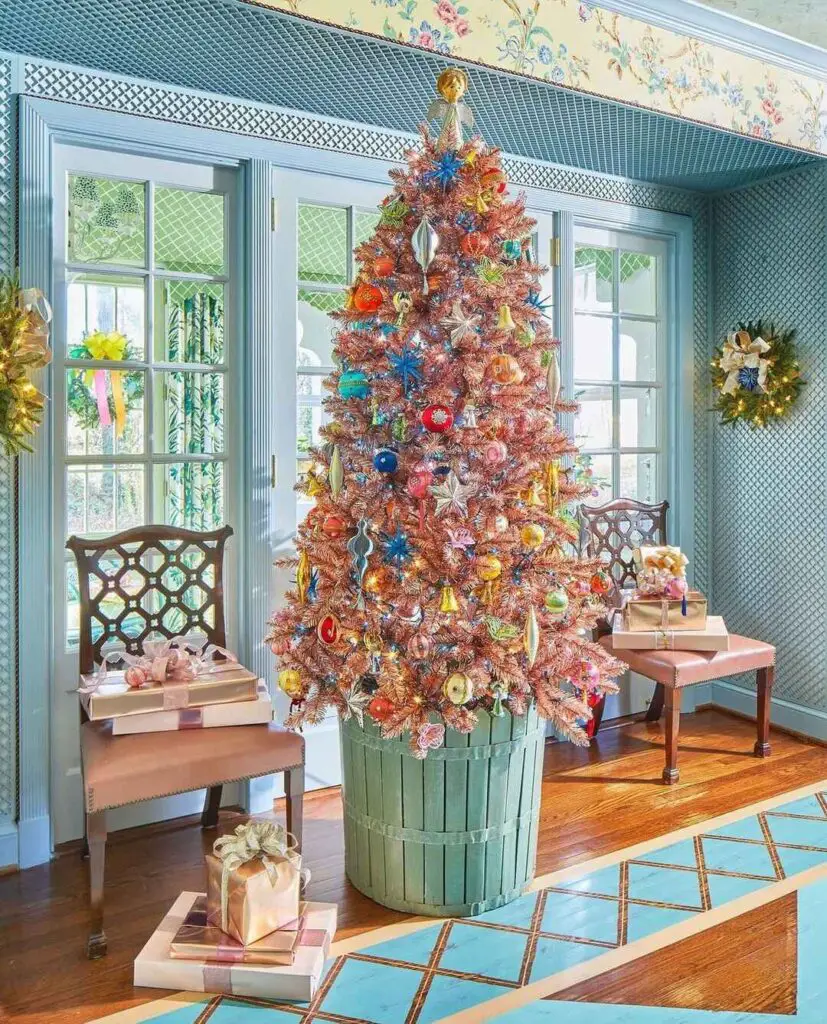 A vibrant, ornament-filled Christmas tree in a retro-inspired living space with a green planter box and cozy benches.
