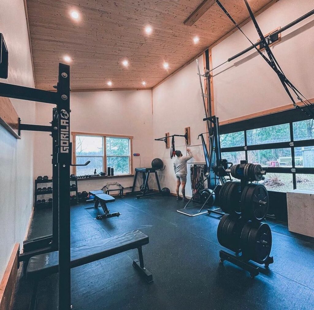 Home gym with wooden ceiling and black exercise equipment