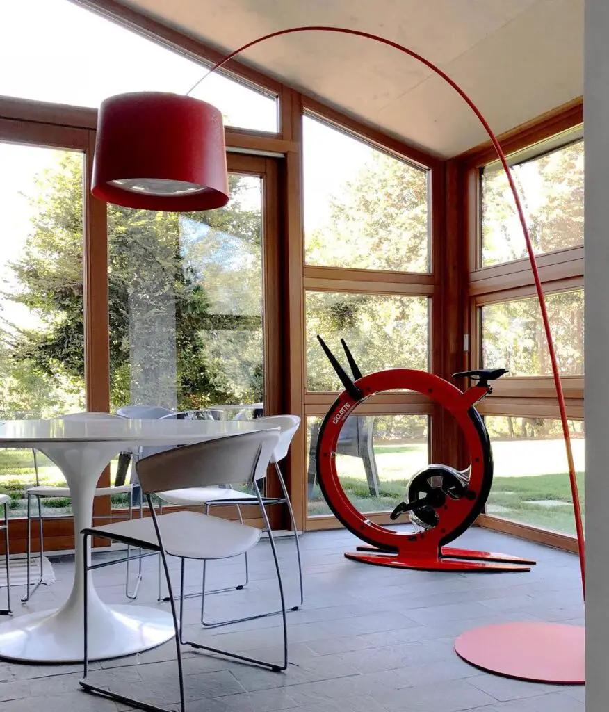 Sunroom with dining table and red exercise bike