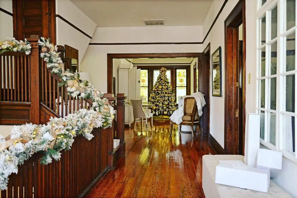 Luxurious living room with decorated Christmas tree and fireplace.