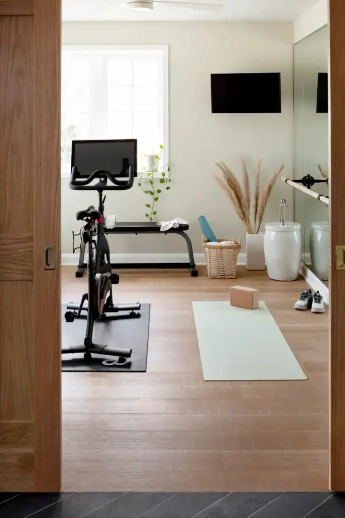 Bright home gym with exercise bike and yoga mat
