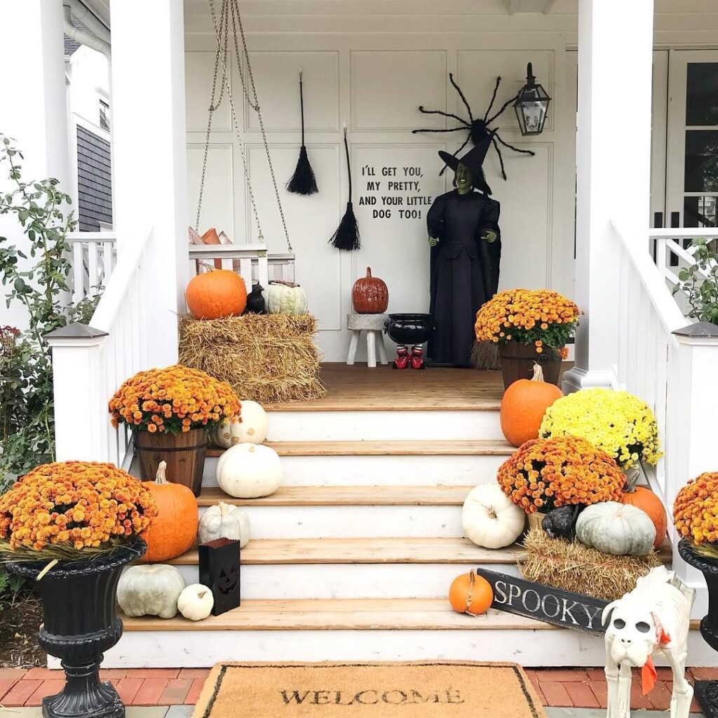 Festive Halloween porch with pumpkins and witch