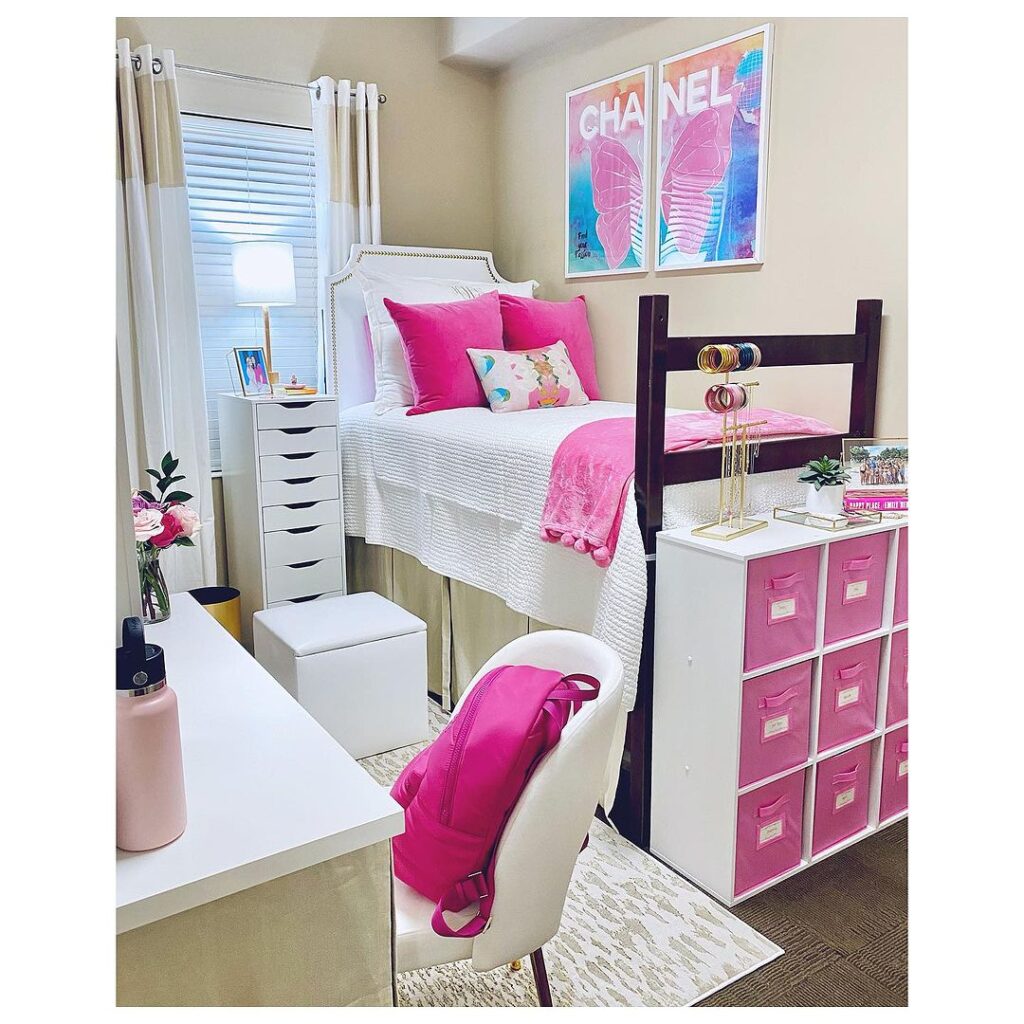 Pink-themed dorm room with organized storage solutions