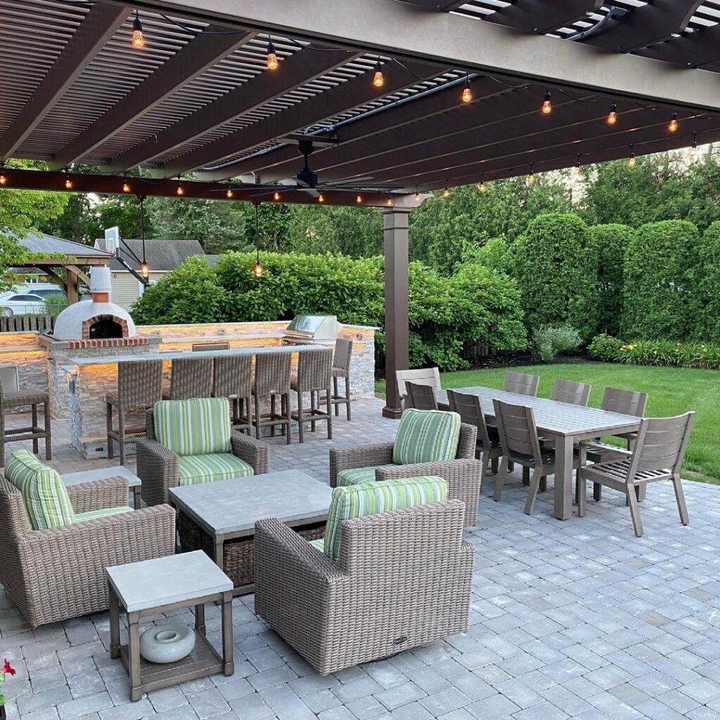 Outdoor patio with pergola kitchen area and seating