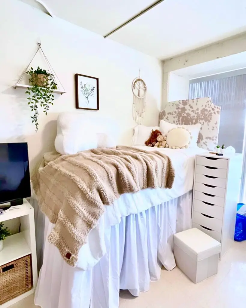 Cozy dorm room with elevated bed and boho decor.