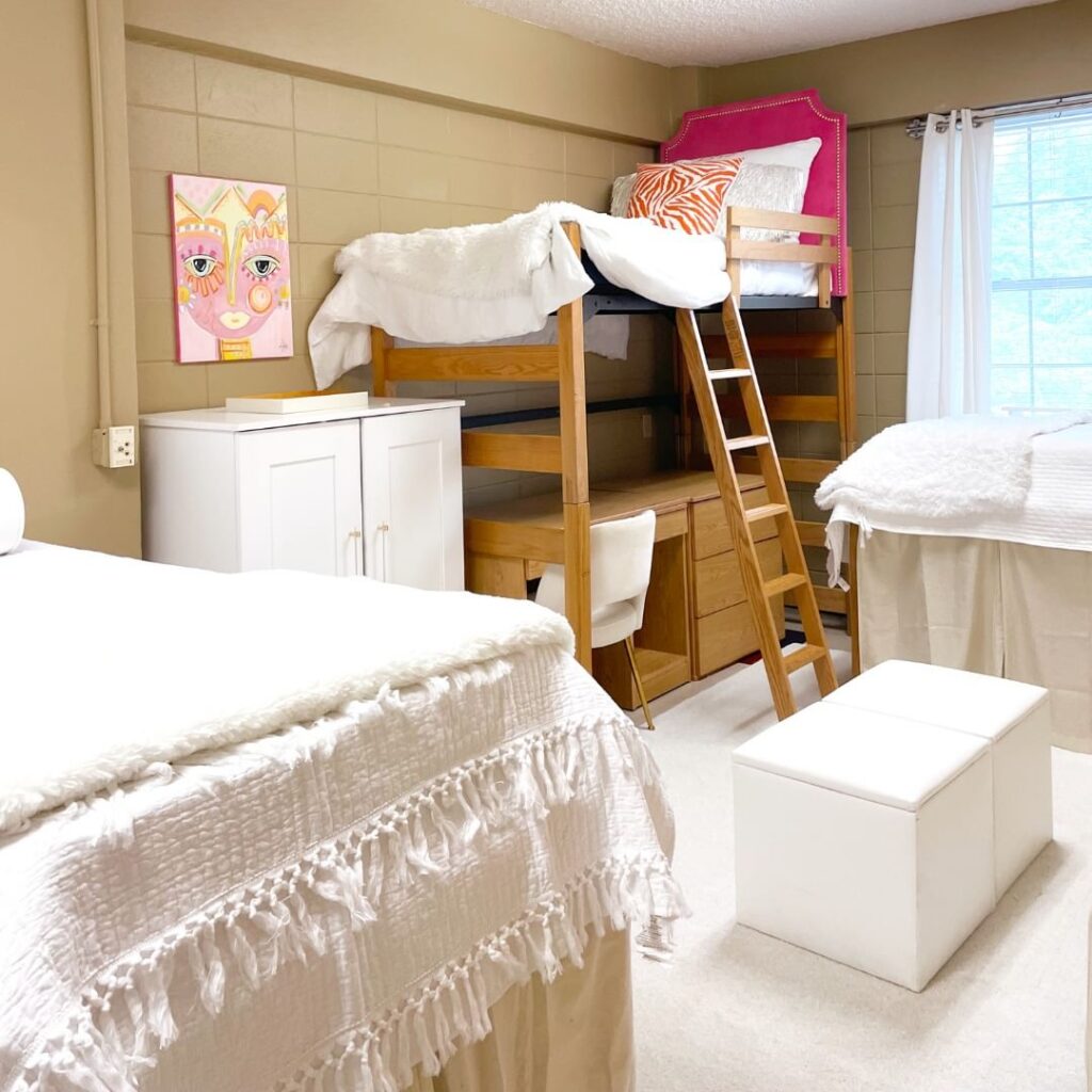Wooden bunk beds, ivory bedding, built-in shelves, bohemian accents.
