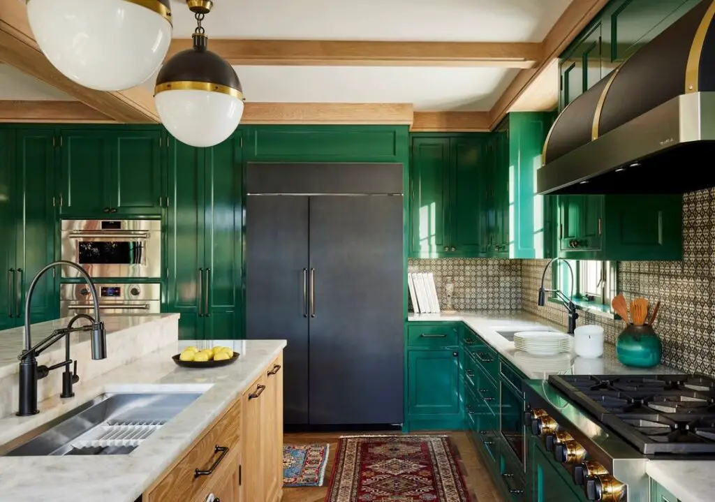 Luxurious green kitchen with wooden accents