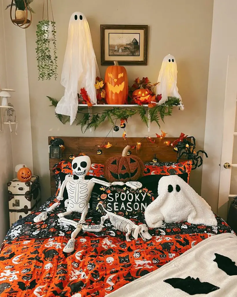 Halloween-themed bedroom with skeleton ghost decorations and festive bedding