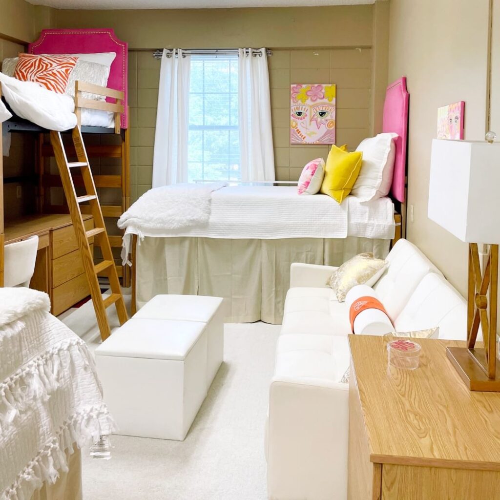 Loft bed, white furniture, bright pink and yellow accents.