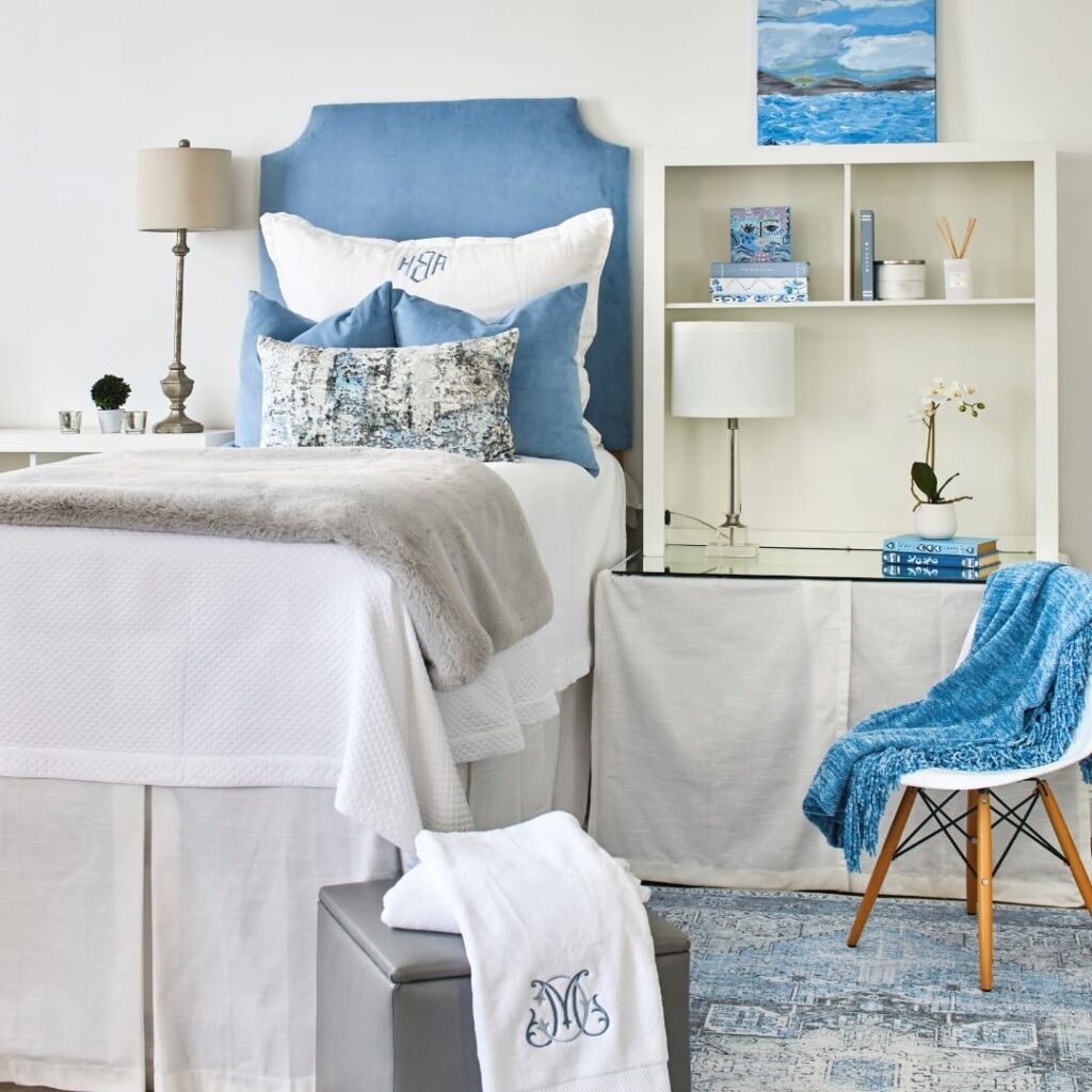 Blue-themed dorm room with coastal-inspired decor and study area.