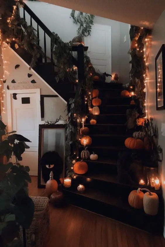 Pumpkin-lined staircase with twinkling Halloween lights.