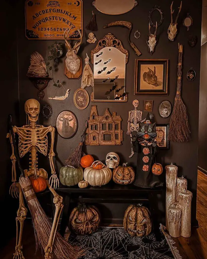 Elaborate Halloween decor with skeleton, pumpkins, and spooky wall art