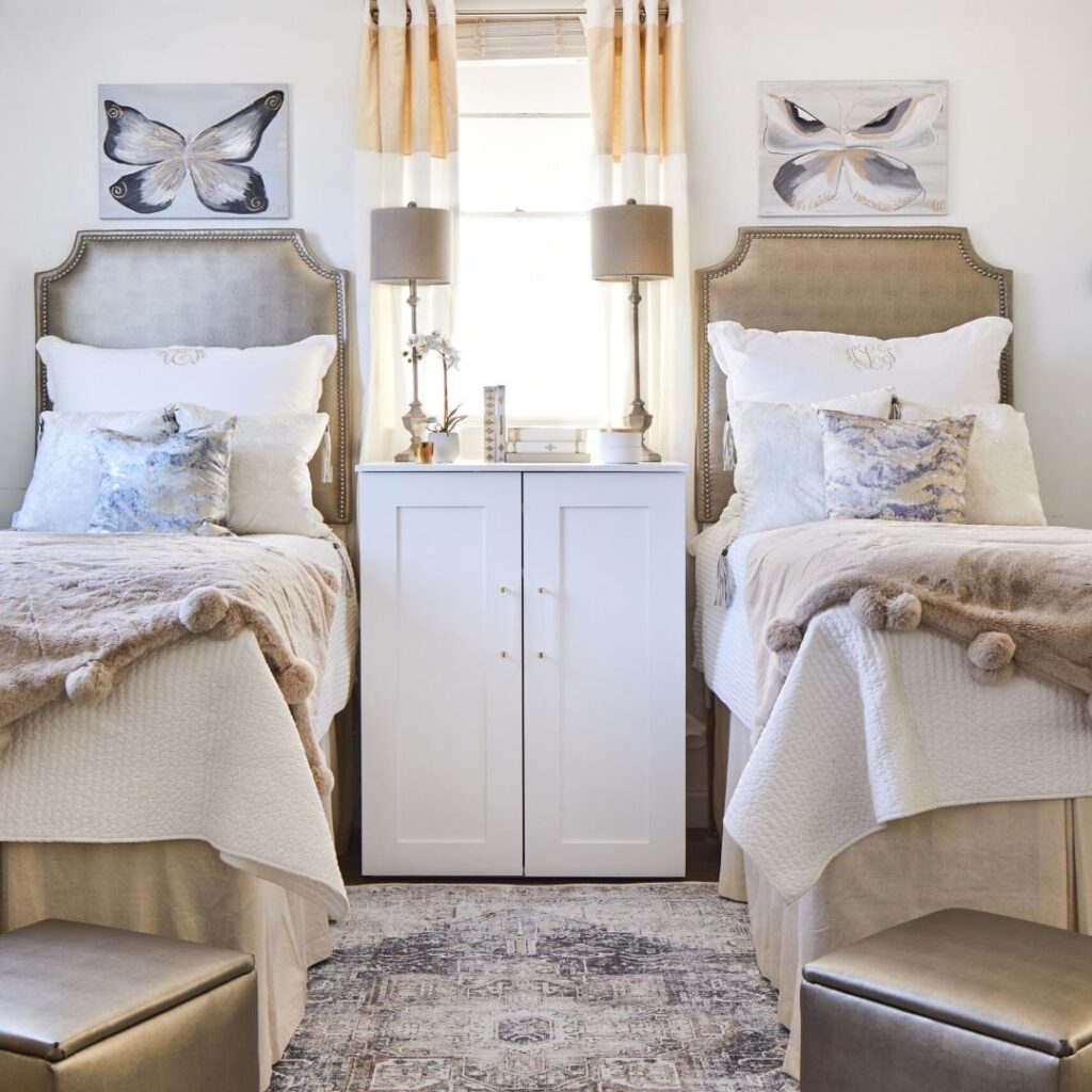 Symmetrical dorm room with butterfly decor and neutral tones.