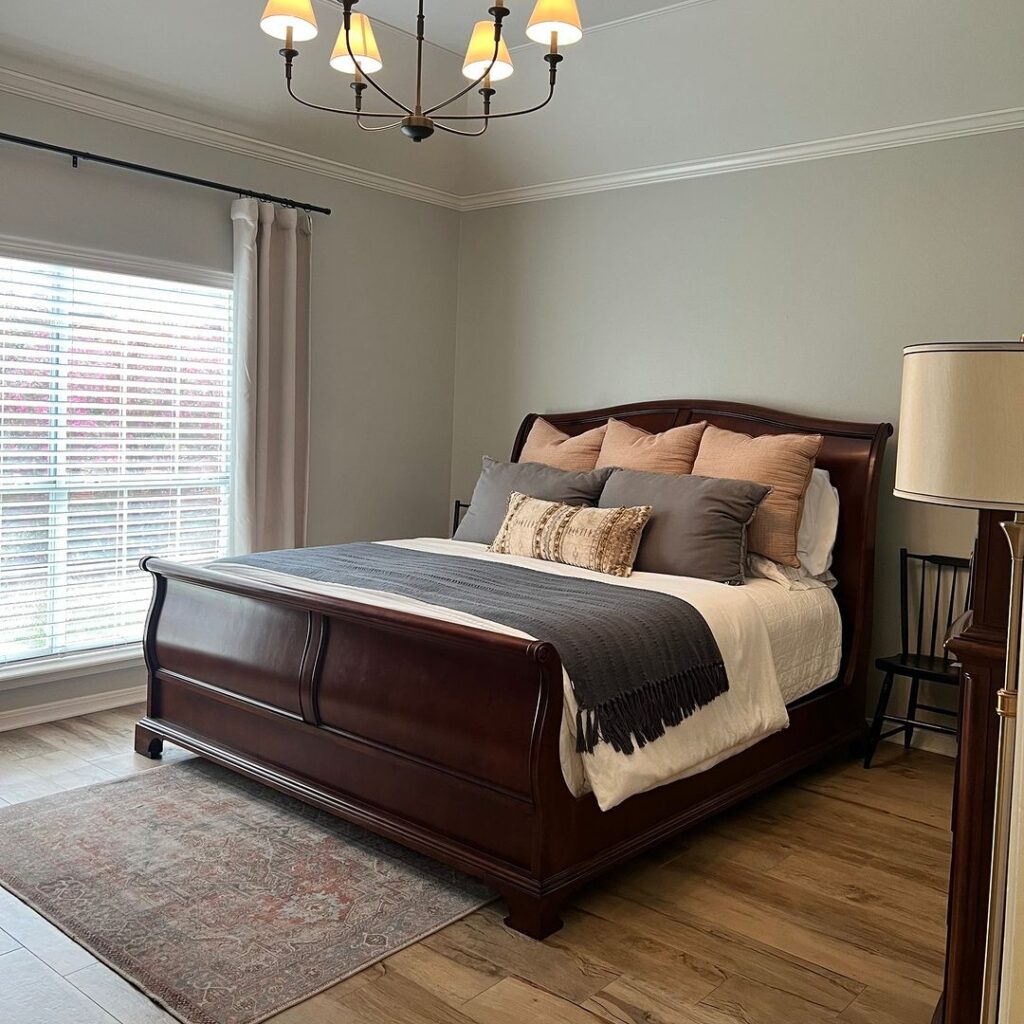 Elegant dark sleigh bed with neutral bedding