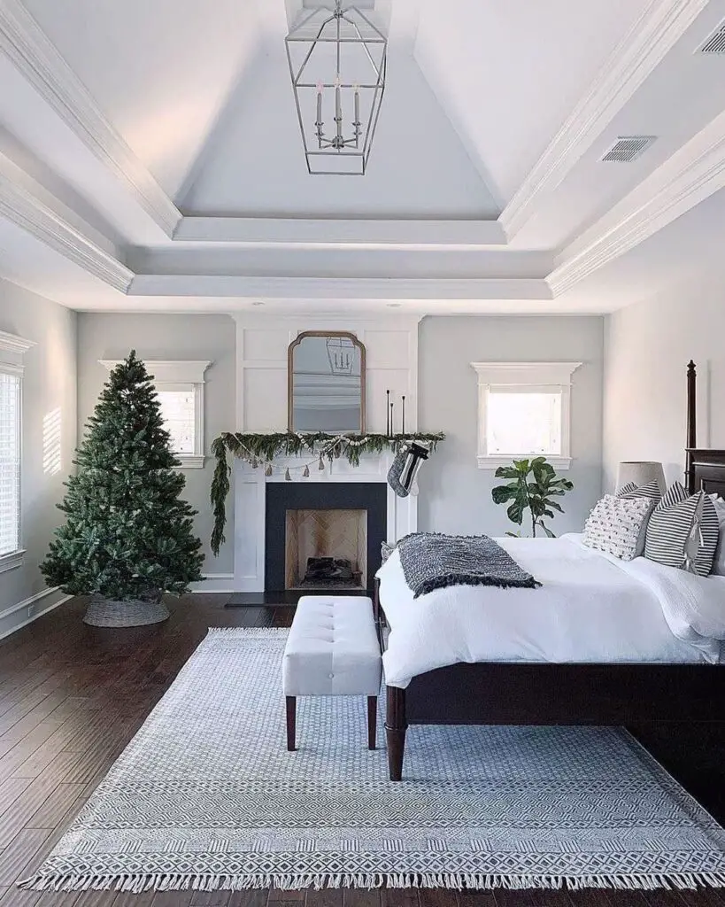 Elegant bedroom with fireplace and Christmas tree