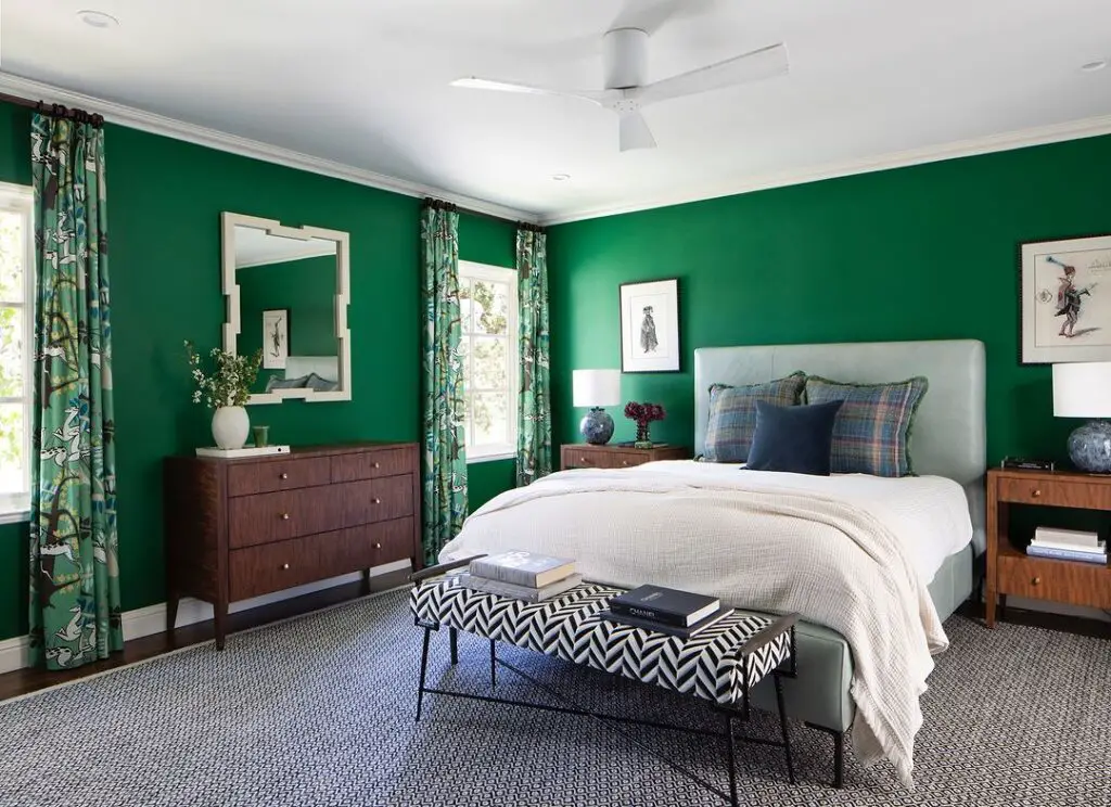 Green bedroom with blue accents wooden furniture and patterned textiles