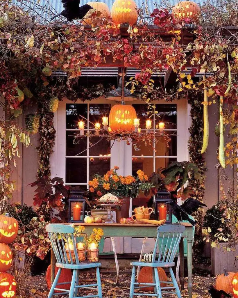 Porch decorated with fall foliage pumpkins and candles