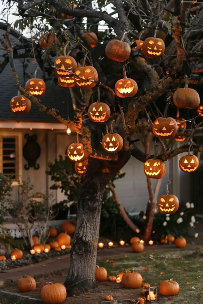 Tree decorated with lit jack-o'-lanterns at night