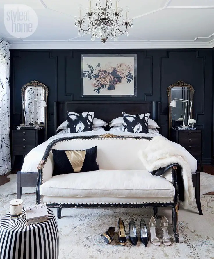 Elegant dark bedroom with white bed and crystal chandelier