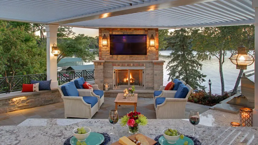 Outdoor patio with fireplace TV and lake view