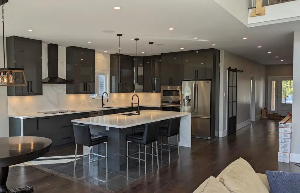 Spacious modern kitchen with dark cabinets and white island