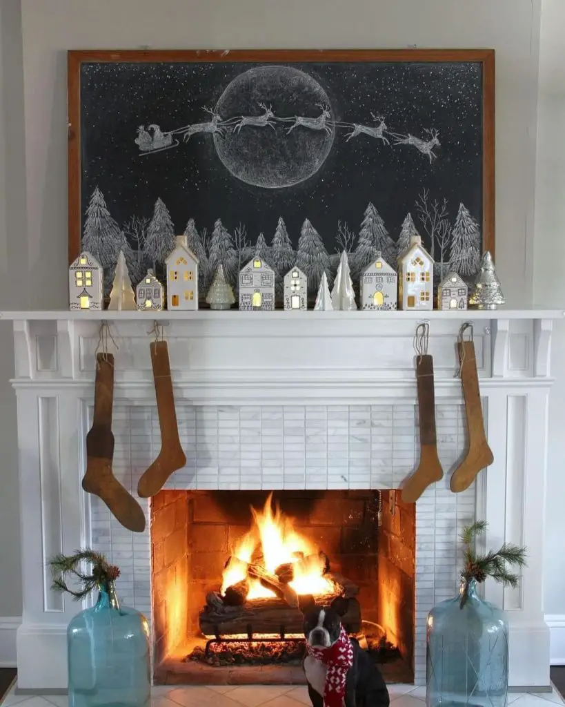 Fireplace with chalk art Santa scene and lit village houses