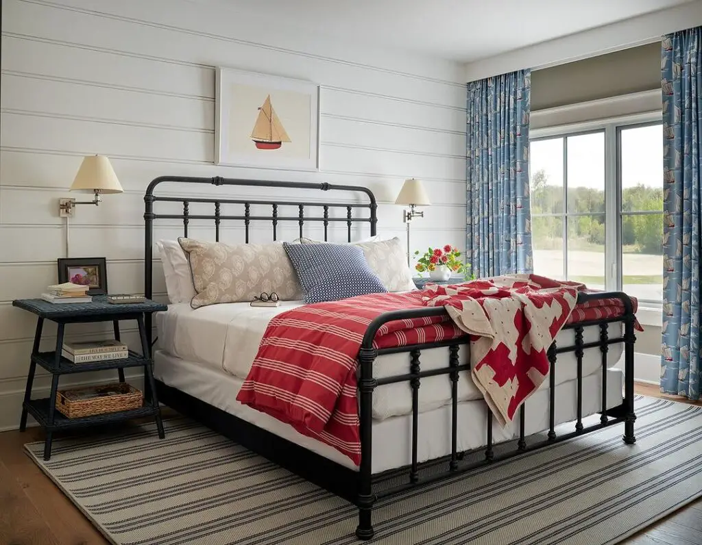 Bedroom with black iron bed and nautical decor