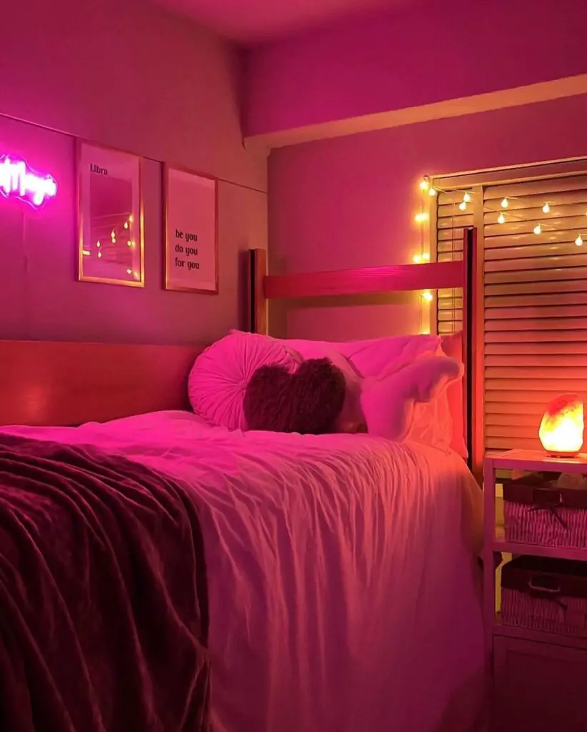 Pink-lit dorm room with neon signs and fairy lights