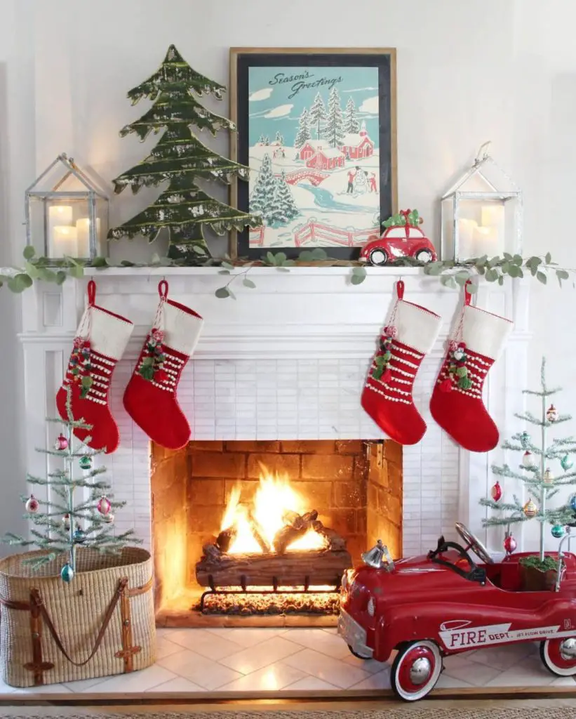 Festive fireplace with vintage decor, stockings, and toy fire truck