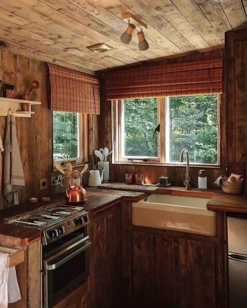 Wooden cabin kitchen with large windows overlooking forest