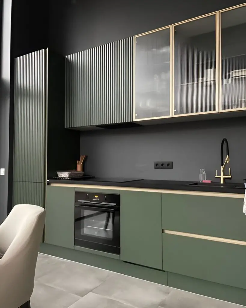 Sage green kitchen with ribbed upper cabinets