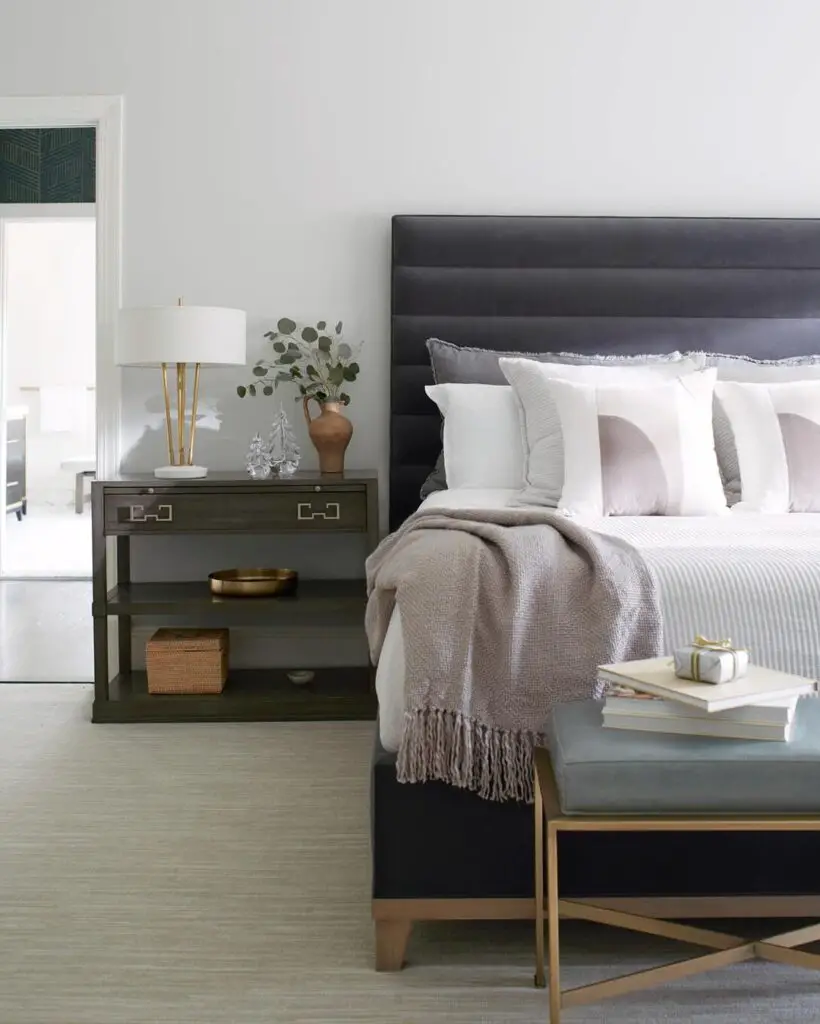 Bedroom with gray headboard and neutral color scheme